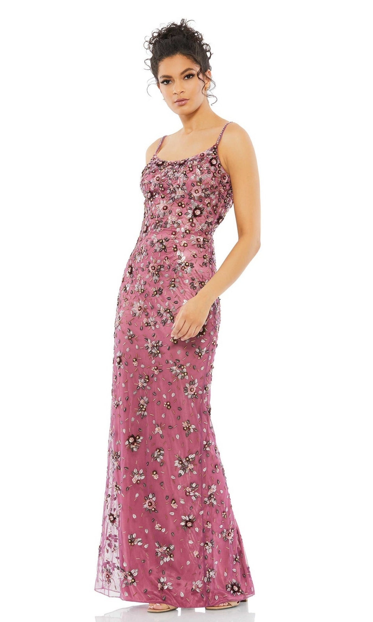 A woman stands in a Floral-Beaded Long Formal Dress—Mac Duggal 5477—sleeveless and floor-length with intricate floral embellishments, gazing to the side against a plain white background.